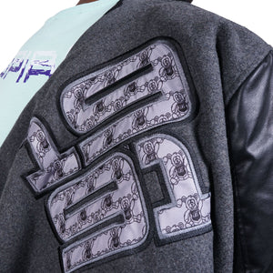 The 1991 fabirc design on the back of the grey baseball jacket